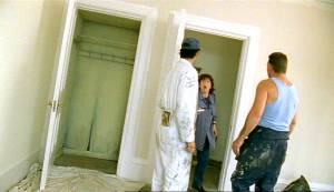 Maddy and the decorators discuss covering up the right hand door into the coriridor from inside the room.