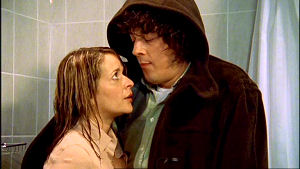 Carla and Jonathan fully clothed in the shower.